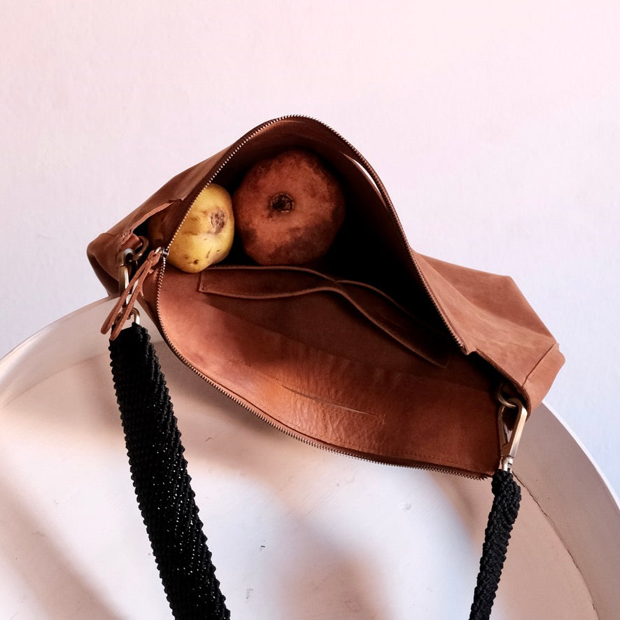 inside of a ogda shoulder bag filled with fruit