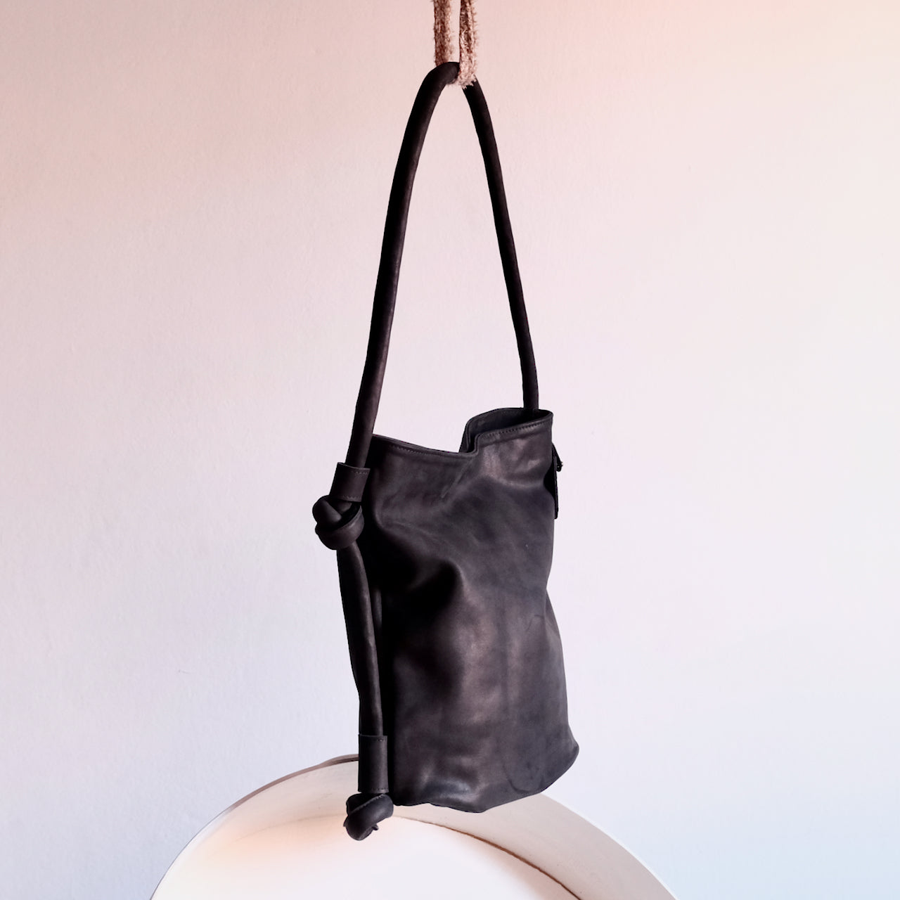 side view of hayat black leather backpack
